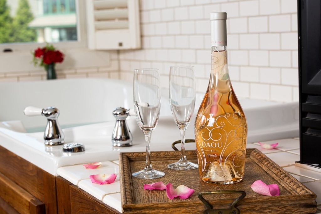 Romantic Getaway in Maryland, a close up of a bottle of bubbles near a bubble bath 